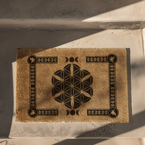 Coir doormat featuring Flower of Life symbol surrounded by lunar phases and protective sigils, in natural tan with black designs.